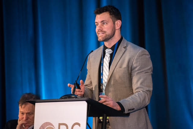 Dr. Phillip Behrens speaking at a conference